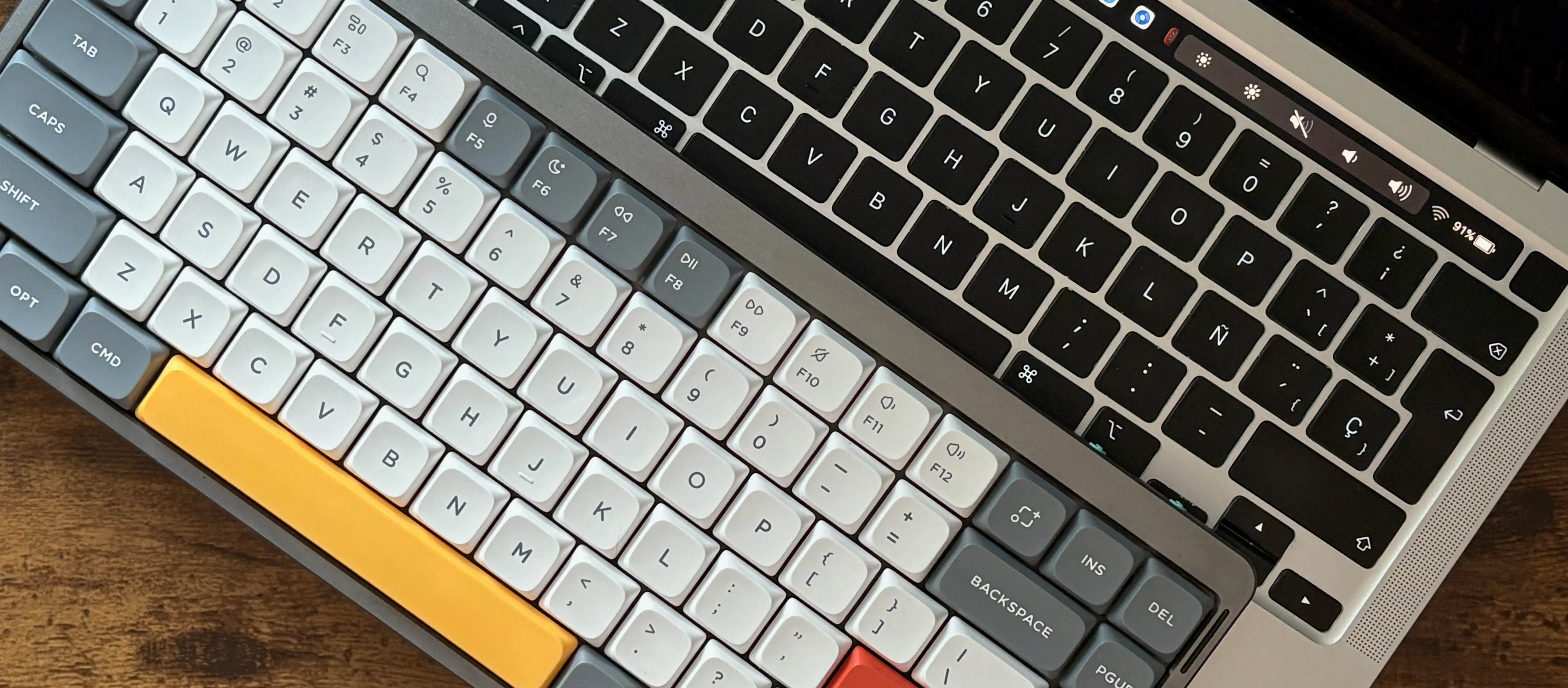 My two keyboards, side to side. Notice my sad, eñeless keyboard.