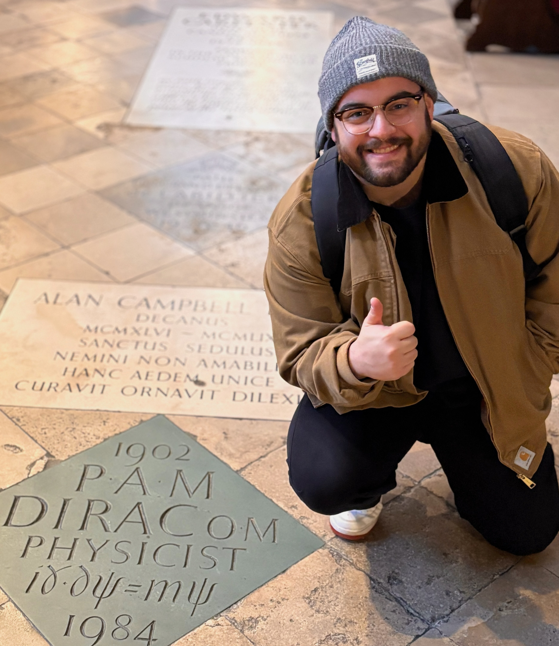 A photo of me doing a thumbs-up next to Dirac's memorial in Westminster Abbey.